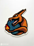 Charizard inspired Pokémon hand-tufted custom wool rug featuring an orange dragon-like character with blue wings, red flame details, sharp teeth, and sculpted 3D artwork by Mayur Rugs.
