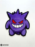 Gengar inspired Pokémon hand-tufted custom wool rug featuring a purple ghost character with red eyes, oversized white teeth, a mischievous grin, and bold black outlines by Mayur Rugs.