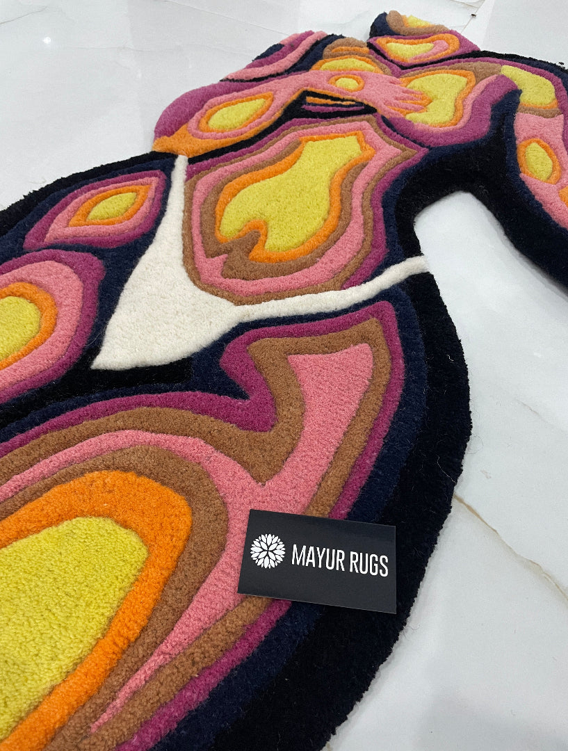 Colorful abstract-patterned rug with 'Maxir Rugs' label on a white floor.