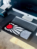 Desk setup with a computer monitor, keyboard, and mouse on a desk.