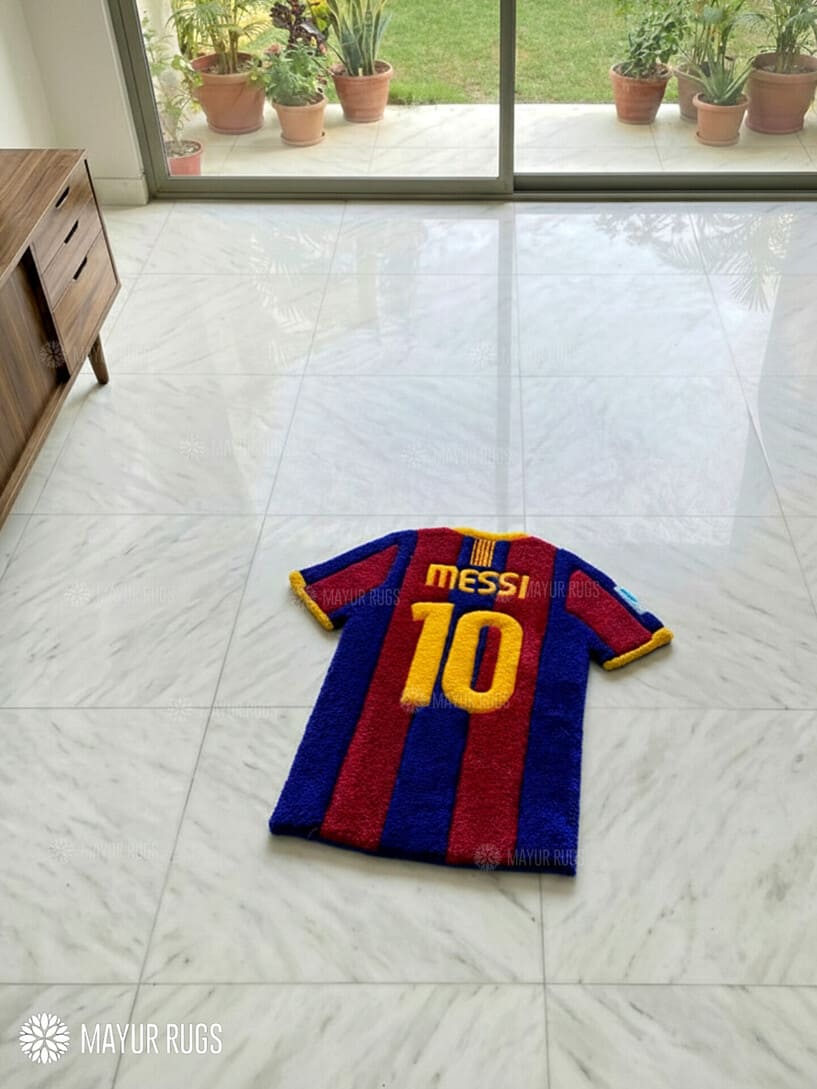 Barcelona football jersey rug with 'Messi 10' on a tiled floor.