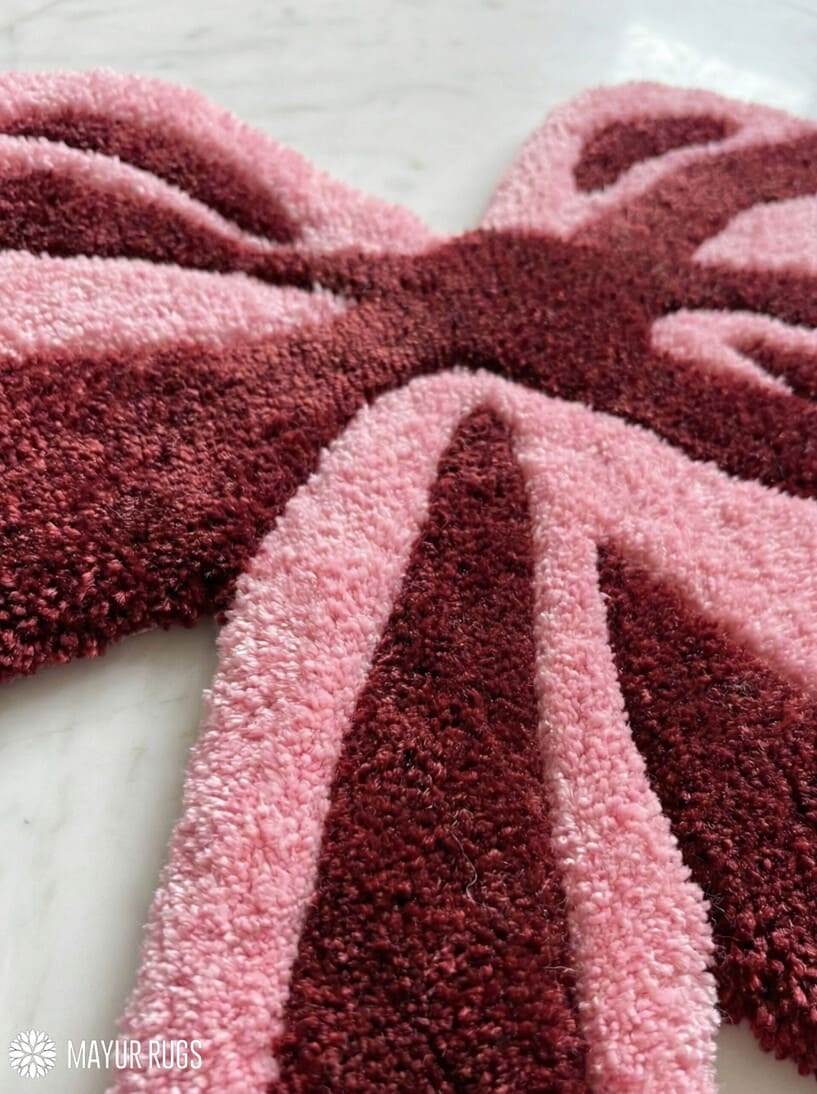 Velvet bow blush hand-tufted wool rug with sculpted ribbon design and soft aesthetic finish, premium custom area rug by Mayur Rugs