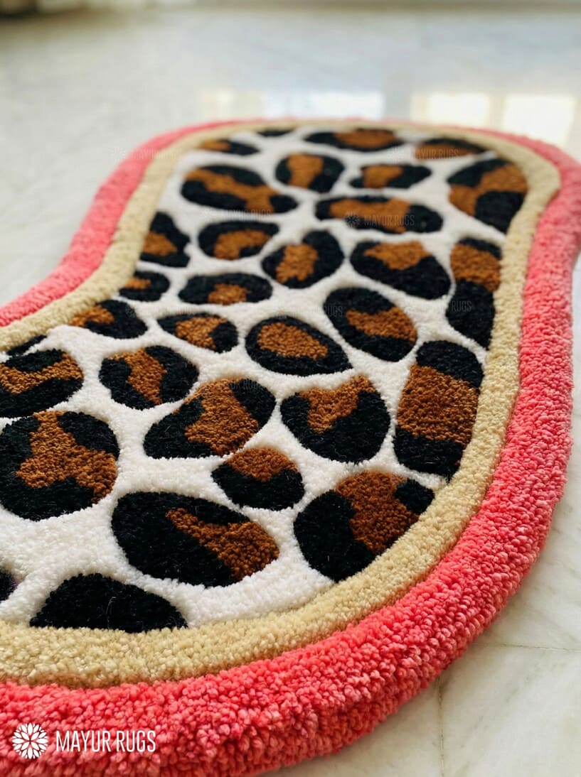 Leopard print oval hand-tufted wool rug with bold animal pattern design, premium custom area rug by Mayur Rugs