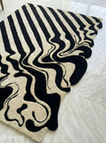Melting liquid abstract hand-tufted wool rug with drip effect silhouette, premium custom area rug by Mayur Rugs
