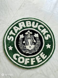 Starbucks Coffee logo on a round green rug with white border