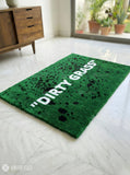 Dirty grass typography hand-tufted wool rug with green textured design, premium custom area rug by Mayur Rugs