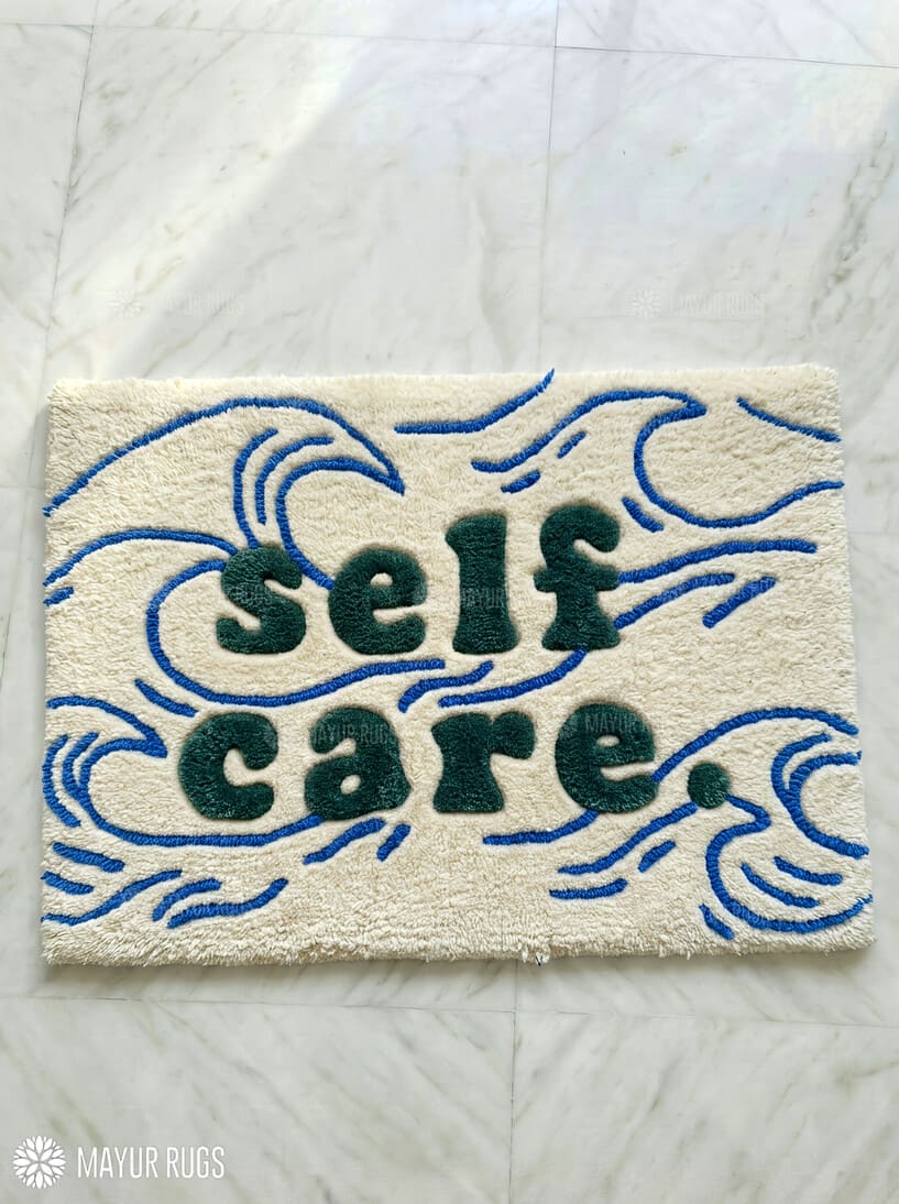 Self Care typography hand-tufted wool rug with minimalist wave aesthetic design by Mayur Rugs