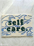 Self Care typography hand-tufted wool rug with minimalist wave aesthetic design by Mayur Rugs