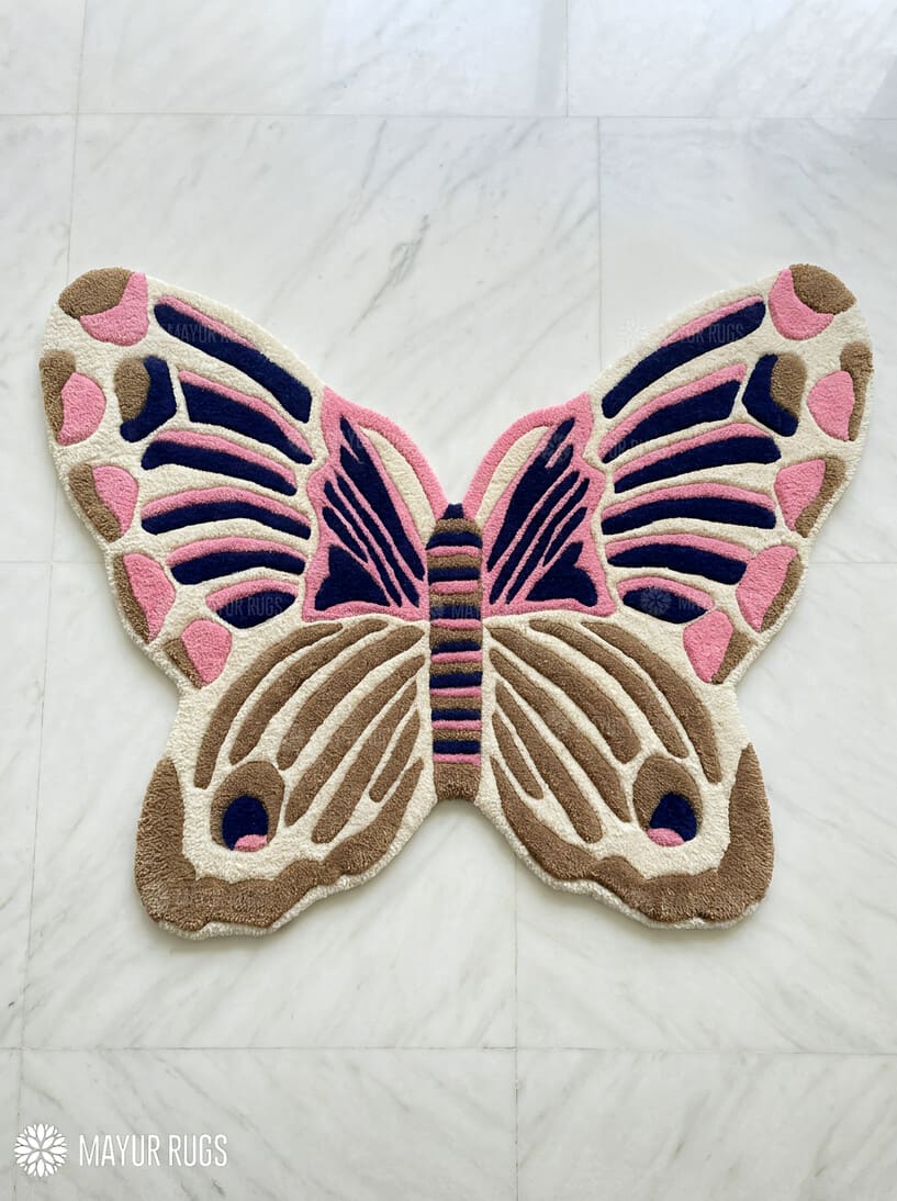 Butterfly-shaped rug with pink and brown colors on a white background