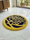 Round rug with 'The Lord of the Rings' design on a white floor.
