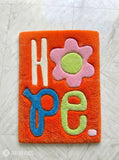 HOPE typography hand-tufted wool rug with minimalist inspirational aesthetic design by Mayur Rugs