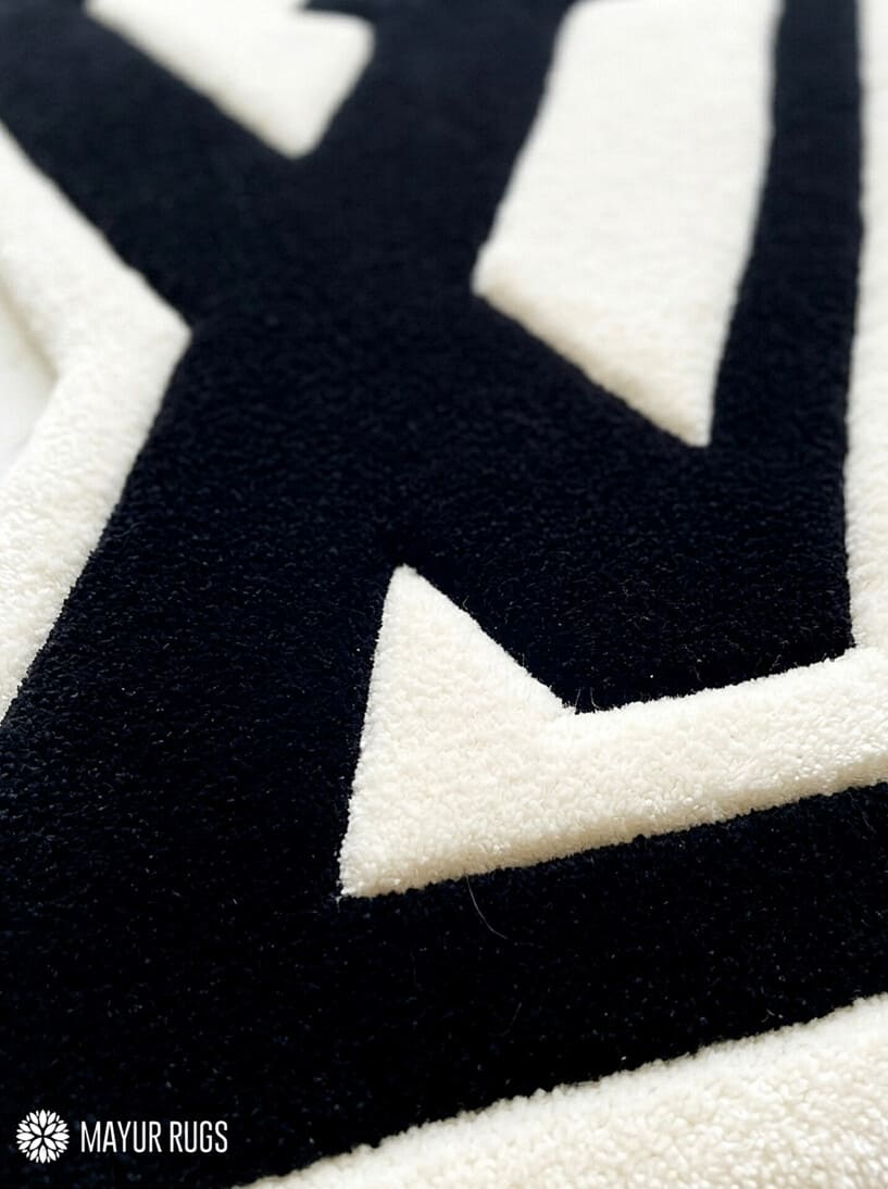 LV logo inspired custom hand-tufted wool rug with luxury streetwear aesthetic design by Mayur Rugs