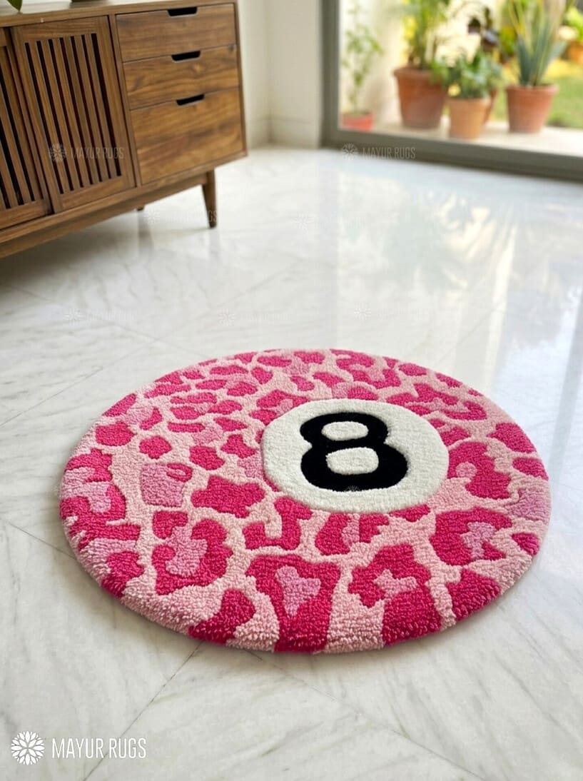 Round pink leopard print rug with number 8 on a white floor.
