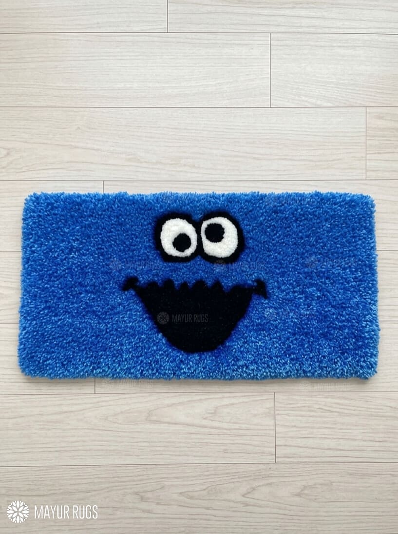 Blue monster-inspired hand-tufted keyboard rug with playful cartoon aesthetic by Mayur Rugs