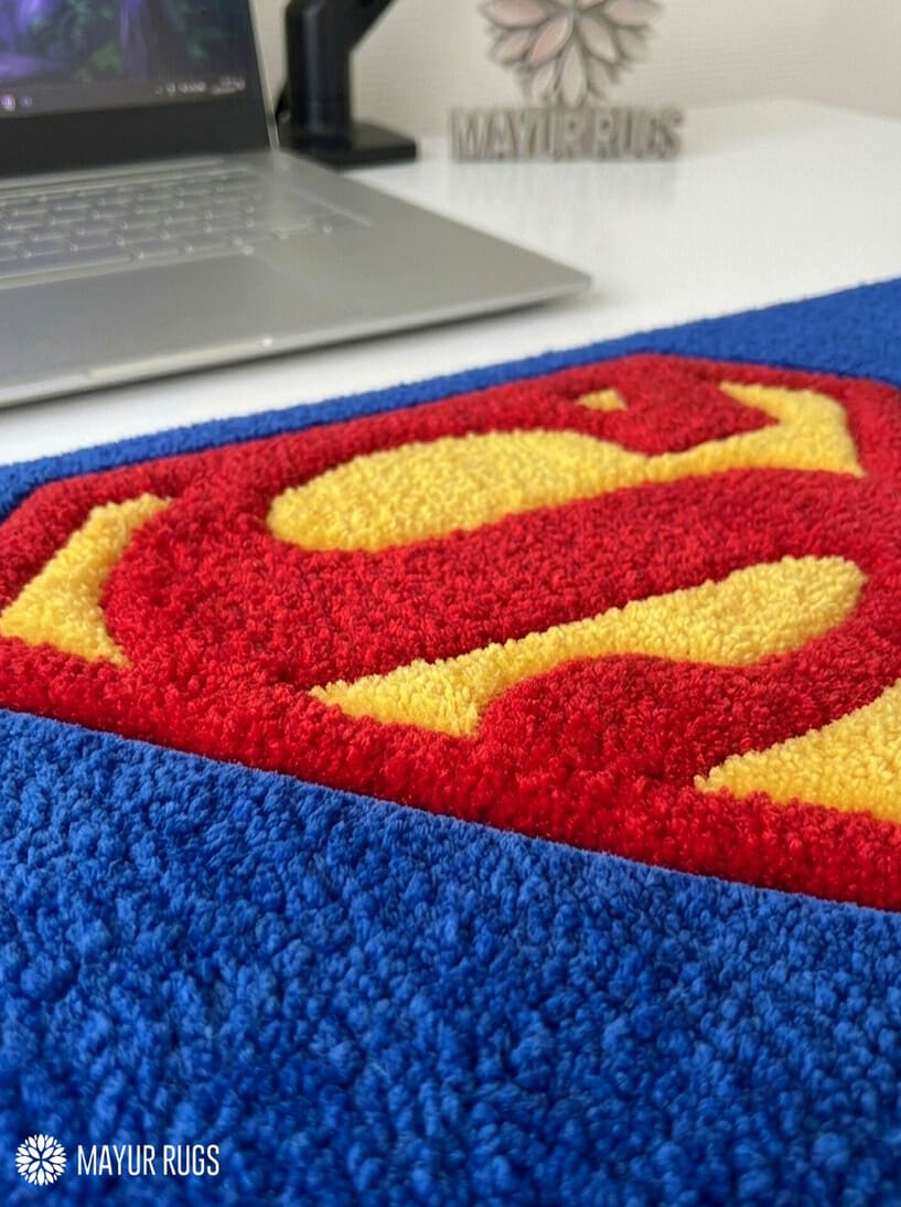 Superman inspired hand-tufted keyboard rug with superhero gaming aesthetic by Mayur Rugs
