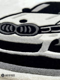 Luxury sports car inspired hand tufted wool rug featuring performance automotive artwork by Mayur Rugs