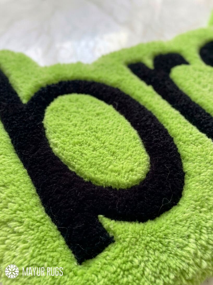 Lime green brat text hand-tufted wool rug featuring bold typography aesthetic by Mayur Rugs