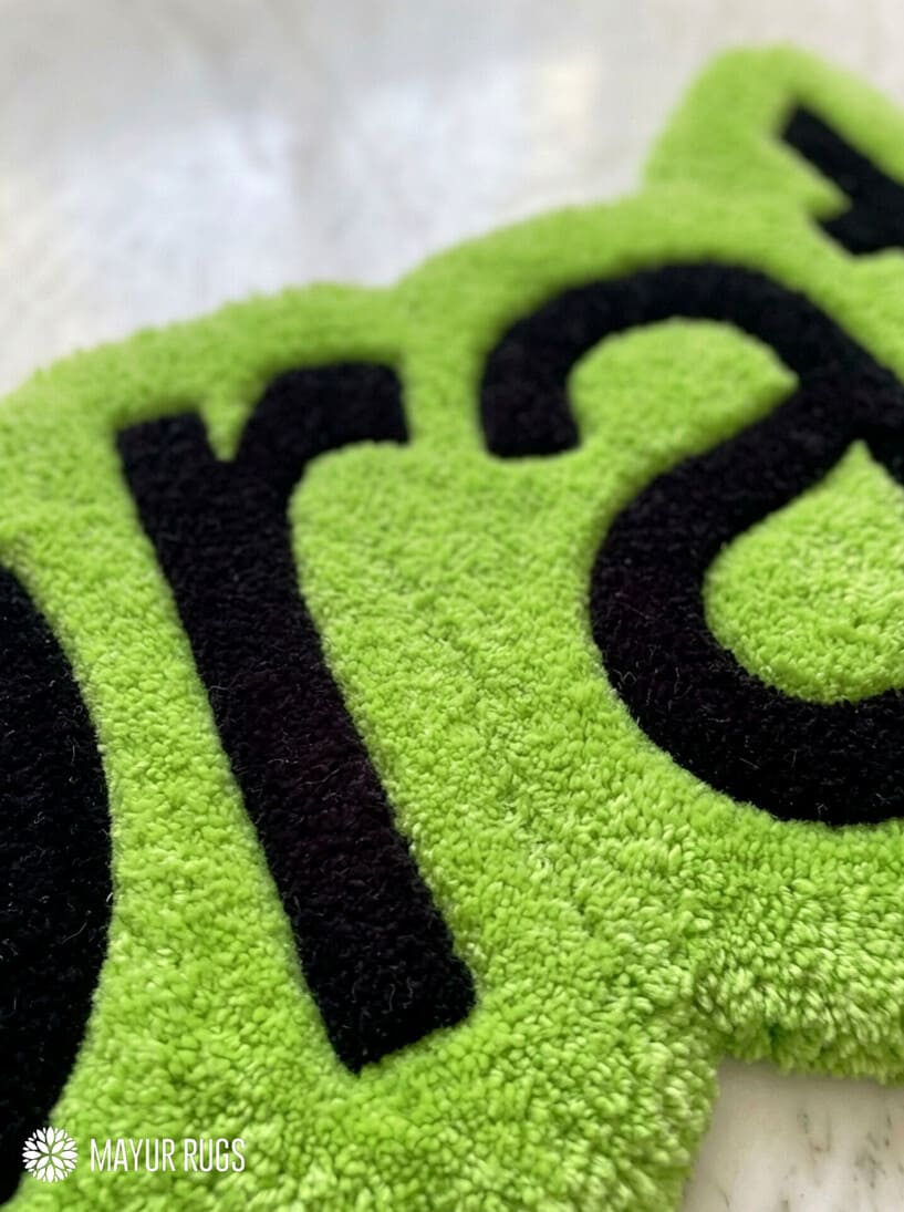 Lime green brat text hand-tufted wool rug featuring bold typography aesthetic by Mayur Rugs