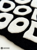 You Look Good typography hand-tufted wool rug with bold black and white affirmation design by Mayur Rugs