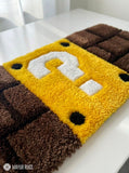 Shop Mario Question Block Keyboard Rugs by Mayur Rugs. Handmade using premium New Zealand wool with iconic retro gaming artwork and luxurious plush texture.