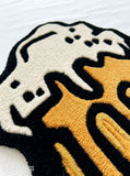Beer stein hand tufted wool rug featuring overflowing foam and pub inspired artwork by Mayur Rugs