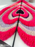 Pink half heart loop and cut hand tufted 3D wool rug featuring layered heart pattern artwork by Mayur Rugs