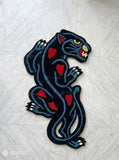 Black Panther tattoo style hand tufted area rug with red heart details handmade by Mayur Rugs