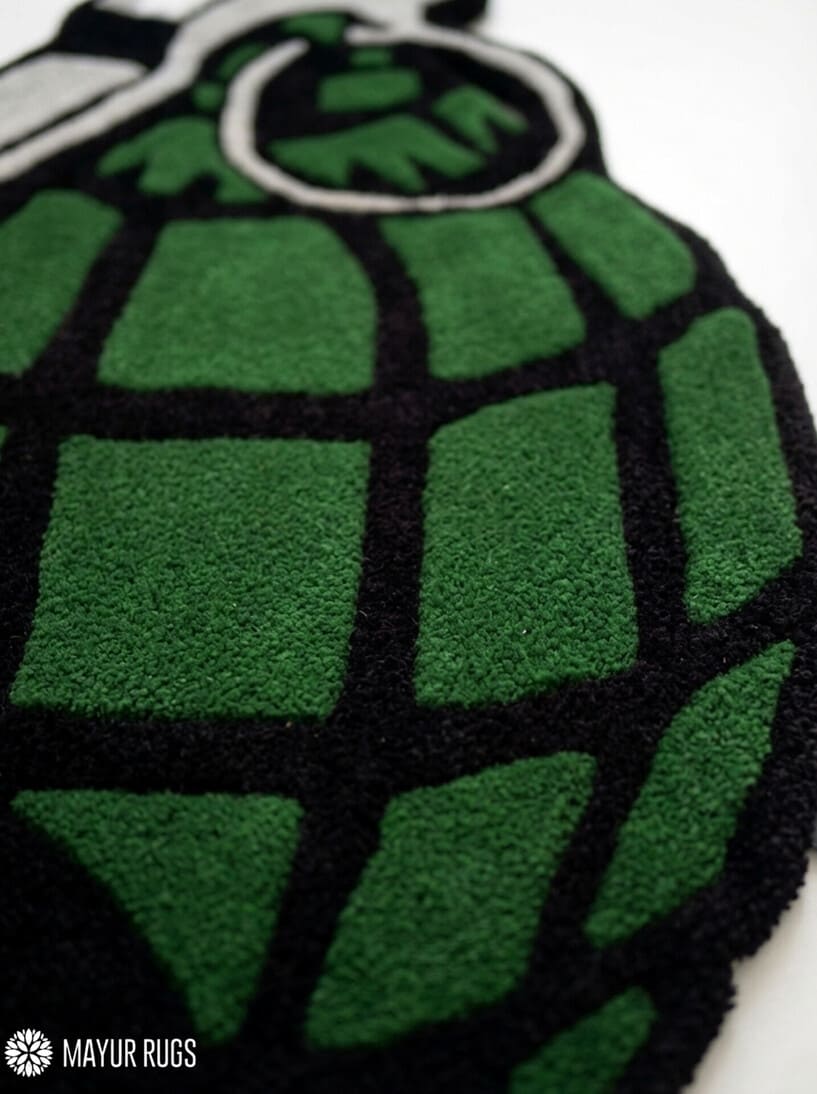 Grenade hand tufted custom wool rug featuring military tactical artwork with olive green grenade design by Mayur Rugs.
