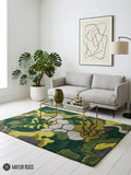 Abstract botanical camo hand-tufted wool area rug featuring layered green organic leaf and floral shapes in olive, moss, lime, beige, and charcoal by Mayur Rugs.