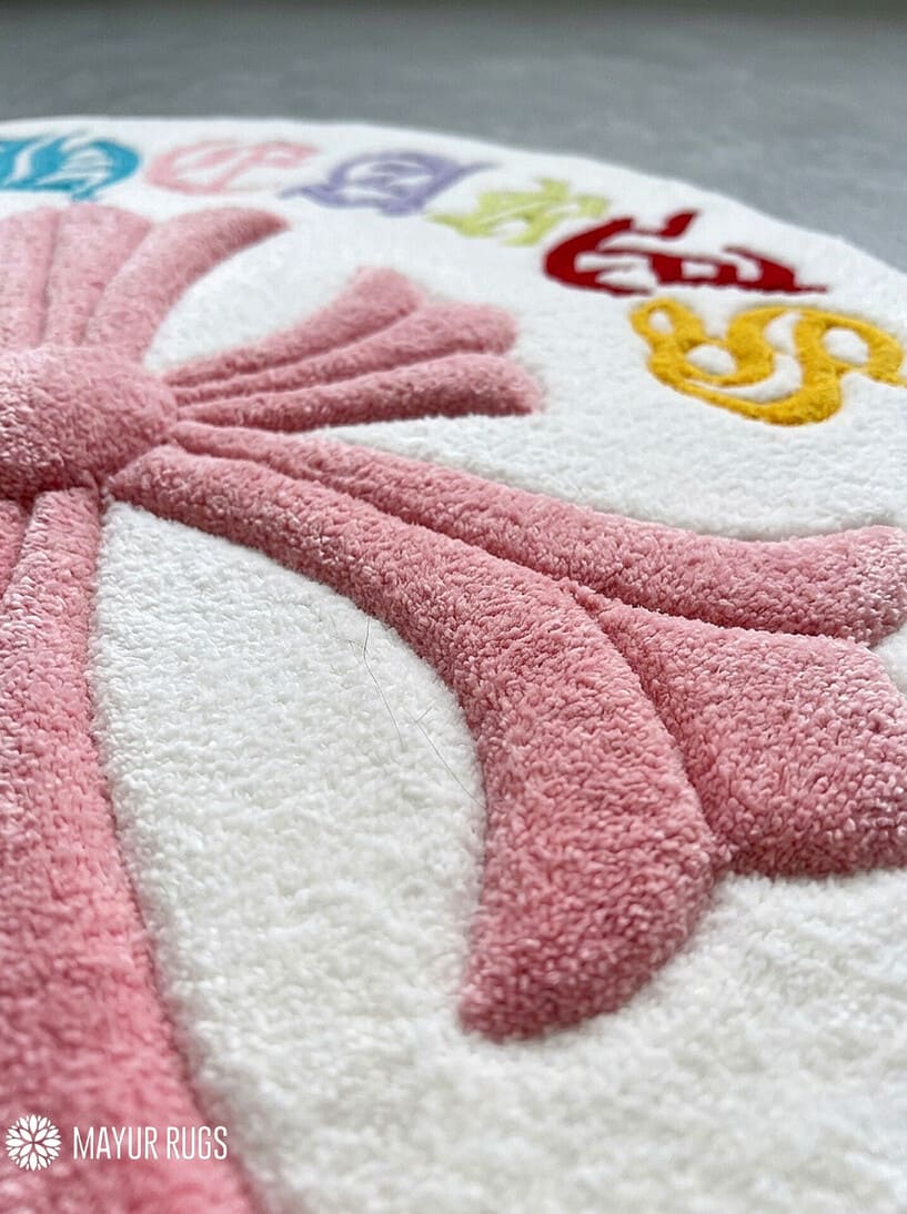 Chrome Hearts inspired colorful cross hand-tufted wool rug featuring a large pink gothic cross with multicolored cross motifs and ornate lettering by Mayur Rugs.
