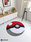 A round Pokéball-inspired rug in red, white, black, and gray, styled on a white floor in a modern room with a sideboard, lamp, and small plant.