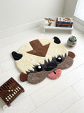 Appa inspired Avatar hand-tufted custom wool rug featuring the flying bison character with cream fur, dark horns, brown forehead arrow, expressive eyes, and pink tongue by Mayur Rugs.
