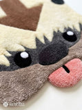 Appa inspired Avatar hand-tufted custom wool rug featuring the flying bison character with cream fur, dark horns, brown forehead arrow, expressive eyes, and pink tongue by Mayur Rugs.
