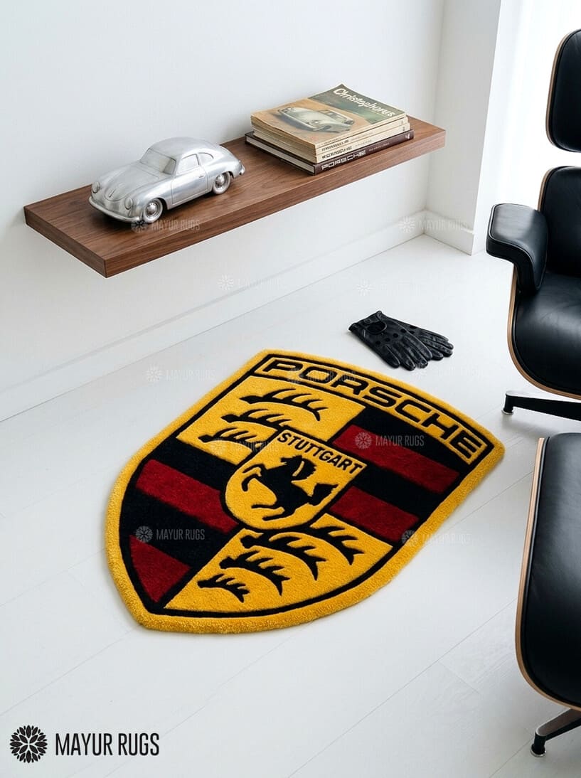 Porsche crest inspired hand-tufted custom wool rug featuring a detailed shield emblem, horse crest, Stuttgart lettering, and red, black, gold, and white automotive design by Mayur Rugs.