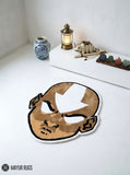 Aang inspired Avatar hand-tufted custom wool rug featuring a bald anime character with a white forehead arrow, expressive eyes, and detailed tan and brown artwork by Mayur Rugs.