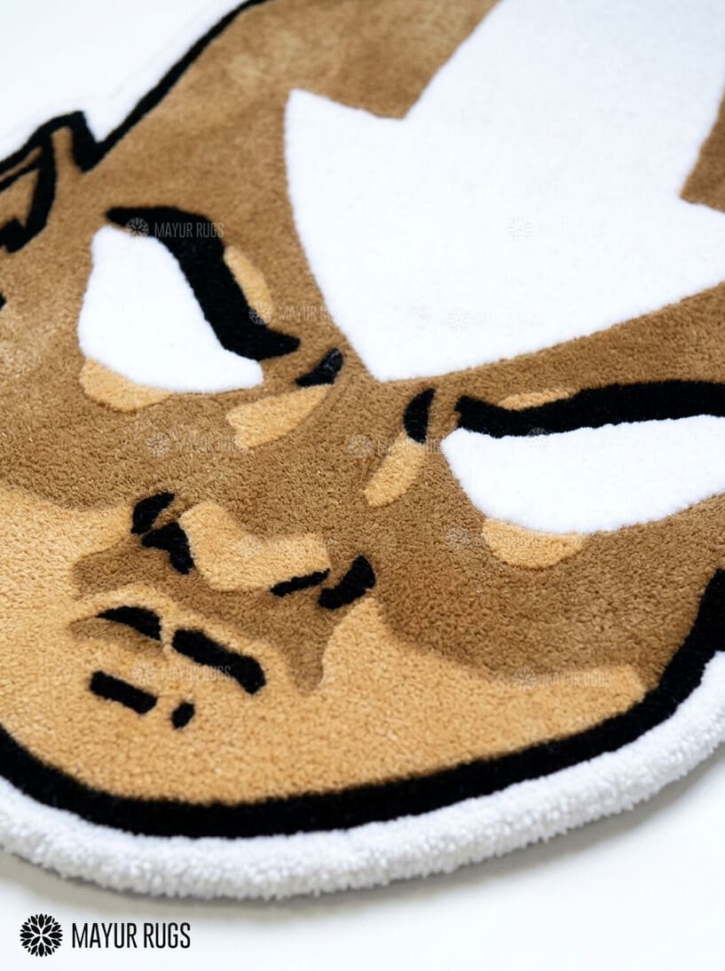 Aang inspired Avatar hand-tufted custom wool rug featuring a bald anime character with a white forehead arrow, expressive eyes, and detailed tan and brown artwork by Mayur Rugs.