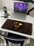 BAPE Ape Head hand-tufted keyboard rug featuring a brown, black, orange, and yellow streetwear graphic on a plush rectangular desk rug by Mayur Rugs.
