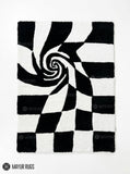 Black and white optical illusion 3D hand-tufted area rug featuring a checkerboard spiral vortex pattern with strong geometric depth by Mayur Rugs.