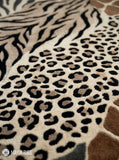 Safari animal print hand-tufted wool area rug featuring zebra stripes, leopard spots, giraffe markings, and tiger-inspired patterns in neutral brown, beige, cream, and charcoal tones by Mayur Rugs.