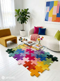 Colorful jigsaw puzzle hand-tufted area rug featuring interlocking puzzle pieces in yellow, orange, pink, red, purple, blue, teal, green, and black by Mayur Rugs.