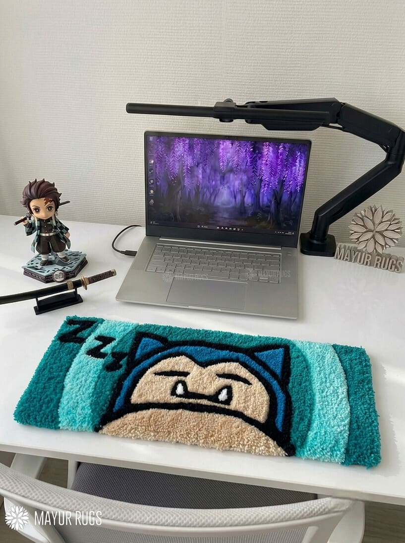 Snorlax inspired Pokémon hand-tufted keyboard rug featuring a sleepy blue and cream character design with pointed ears and expressive eyes for gaming desk and anime décor by Mayur Rugs.