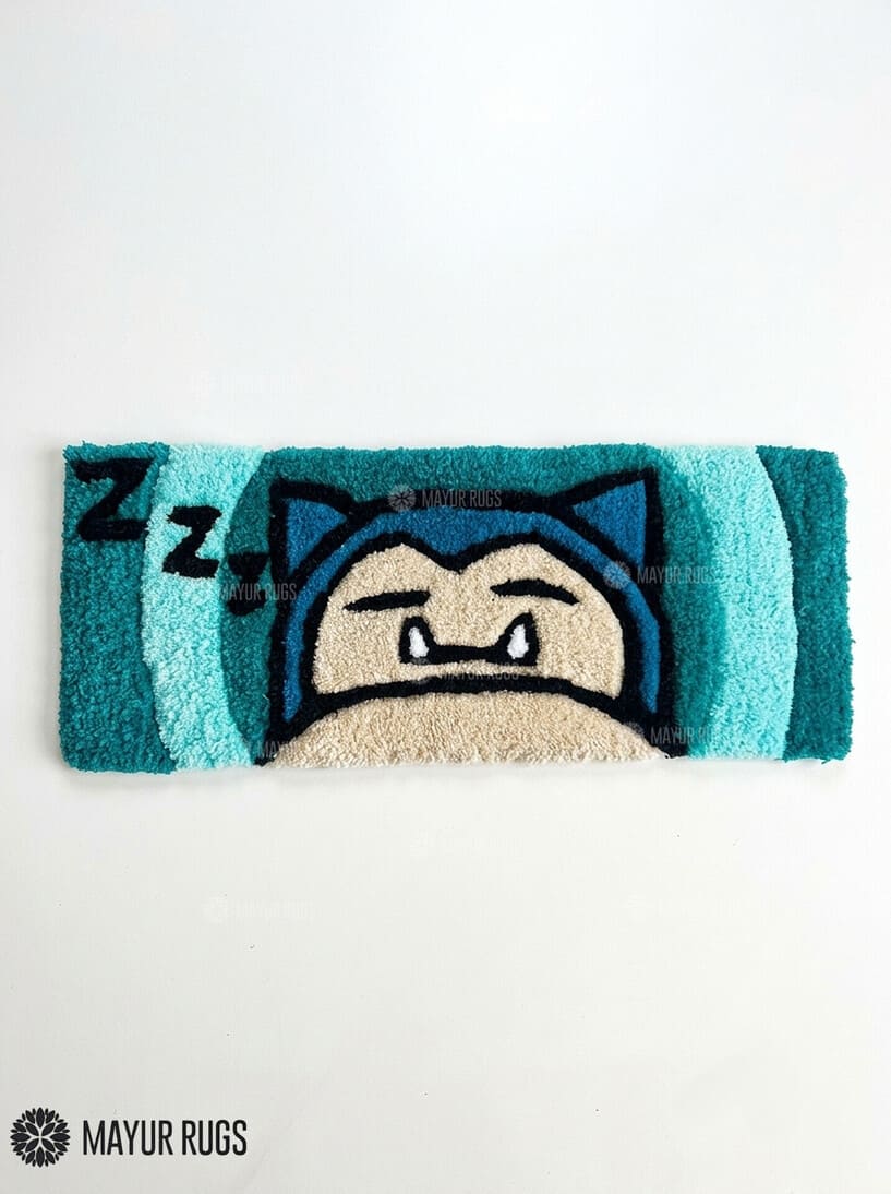 Snorlax inspired Pokémon hand-tufted keyboard rug featuring a sleepy blue and cream character design with pointed ears and expressive eyes for gaming desk and anime décor by Mayur Rugs.