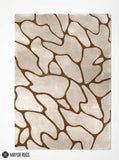 Organic pebble abstract silk and wool hand-tufted area rug featuring irregular cream and beige forms with flowing brown outlines in a neutral modern design by Mayur Rugs.