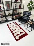 Marvel inspired hand-tufted wool area rug featuring oversized cream-white comic book lettering on a deep red background for superhero and pop-culture décor by Mayur Rugs.