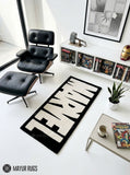 Marvel inspired hand-tufted wool area rug featuring oversized cream-white comic book lettering on a deep red background for superhero and pop-culture décor by Mayur Rugs.