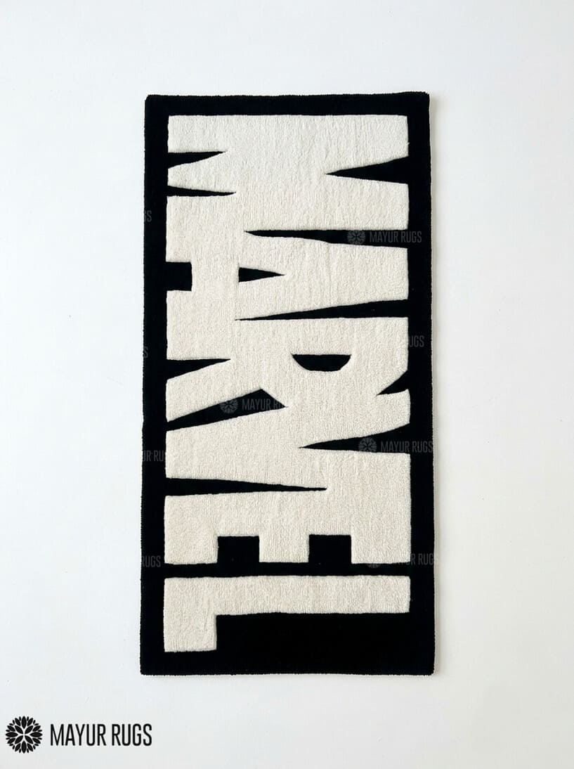 Marvel inspired hand-tufted wool area rug featuring oversized cream-white comic book lettering on a deep red background for superhero and pop-culture décor by Mayur Rugs.