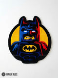 LEGO Batman inspired 3D hand-tufted custom wool rug featuring a black, blue, red, and yellow superhero character design with pointed bat ears, cape details, and a raised bat emblem by Mayur Rugs.