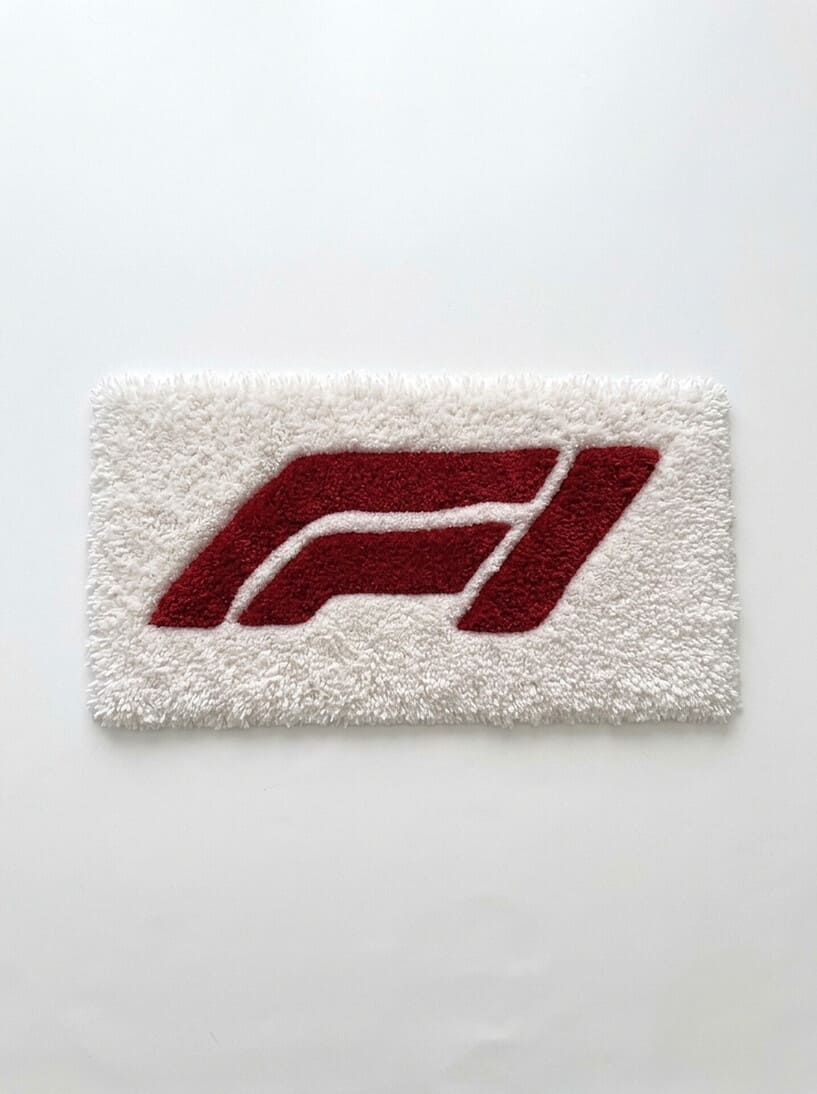 F1 inspired Formula racing hand-tufted keyboard rug featuring a bold red motorsport graphic on a plush white wool base for racing and gaming desk setups by Mayur Rugs.