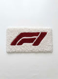 F1 inspired Formula racing hand-tufted keyboard rug featuring a bold red motorsport graphic on a plush white wool base for racing and gaming desk setups by Mayur Rugs.