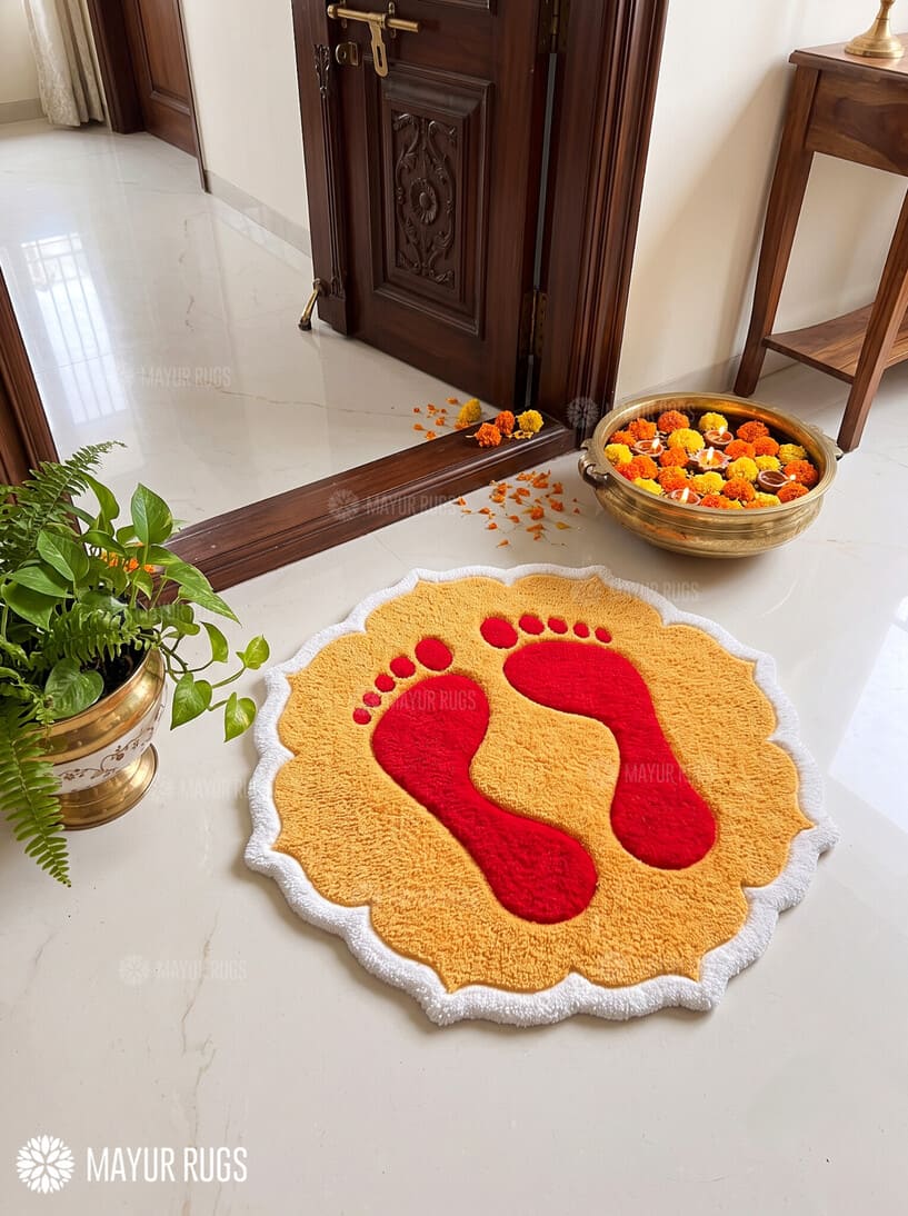 Diwali rangoli-inspired hand-tufted custom wool rug featuring red Lakshmi Charan-inspired footprints on a golden-yellow base with a scalloped ivory-white border by Mayur Rugs.